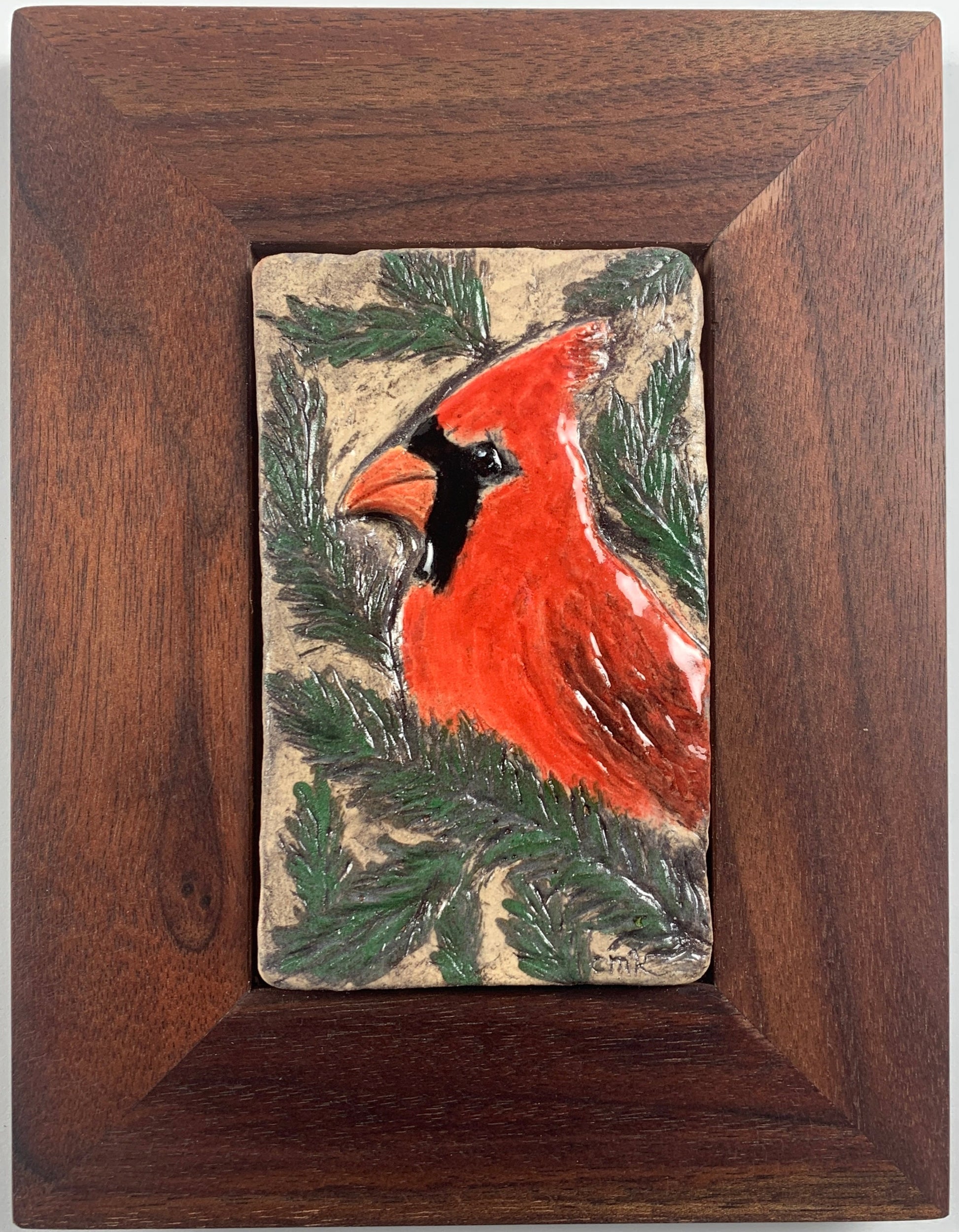 Wooden frame with a painted cardinal on a stone background